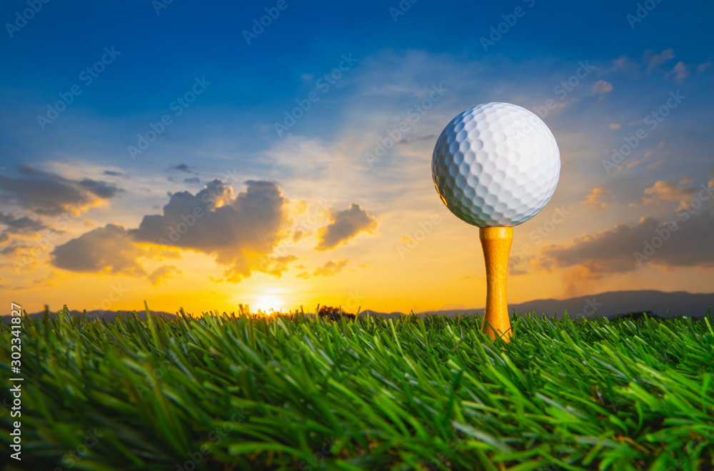 golf ball on tee pegs ready to play in the golf course at sunset with clouds in the evening day back