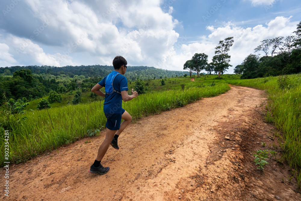 Asian men are running a trail In the natural path