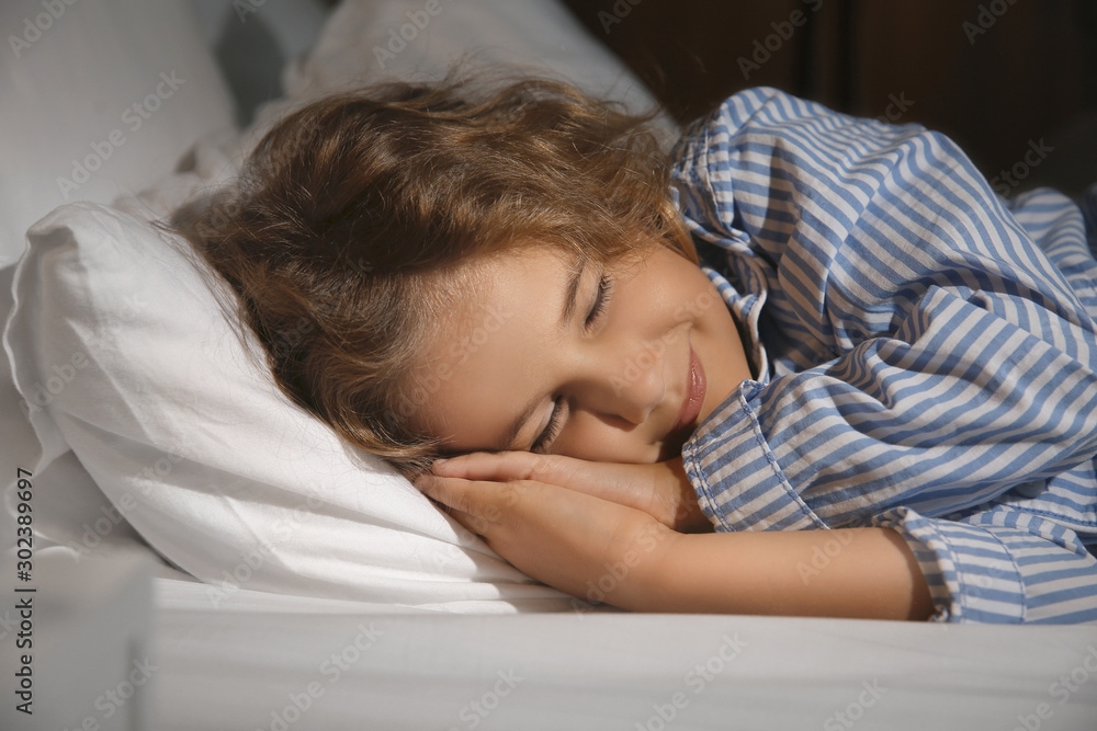 Cute little girl sleeping in bed at night