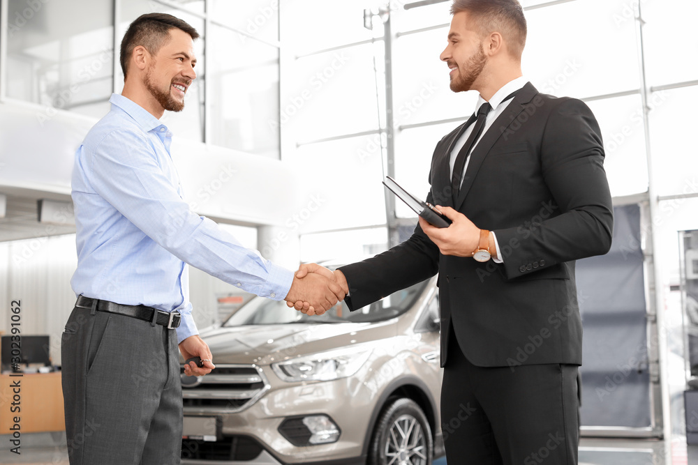 Man buying new car in salon