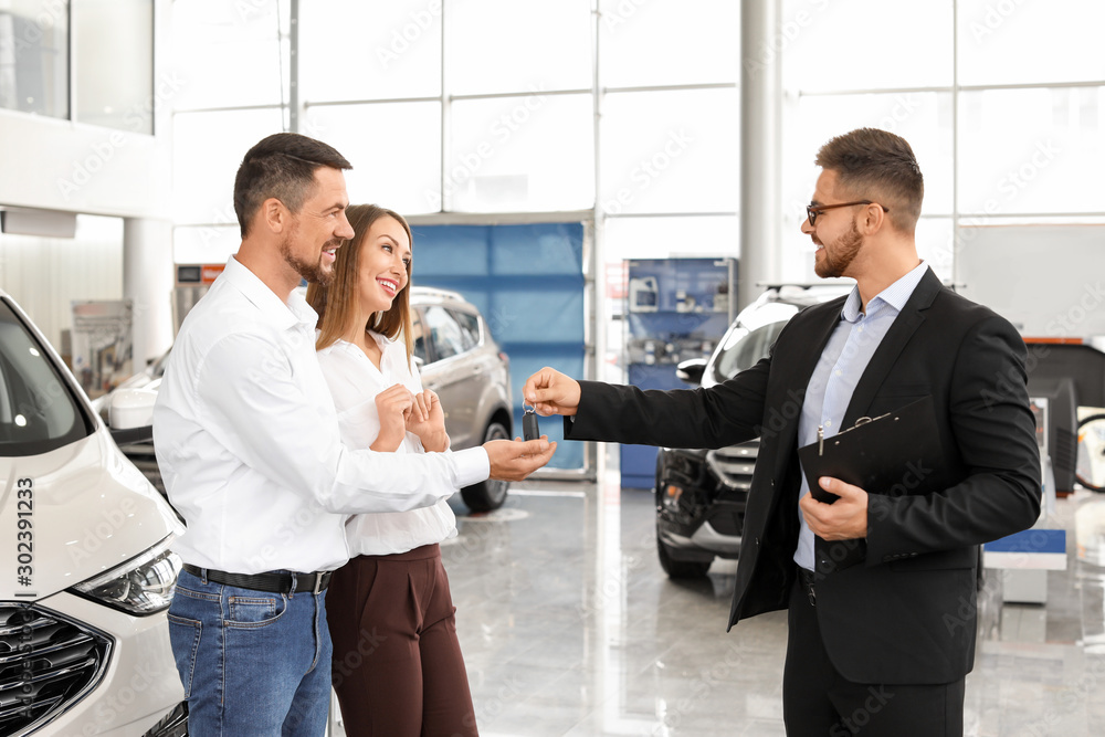 Couple buying new car in salon