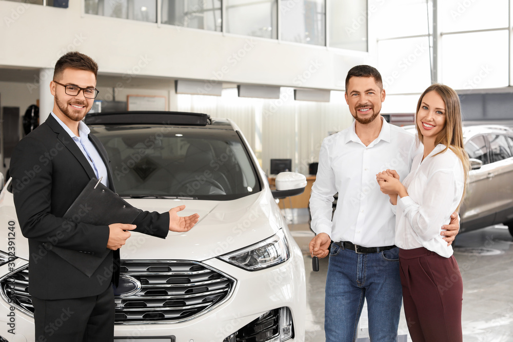 Couple buying new car in salon