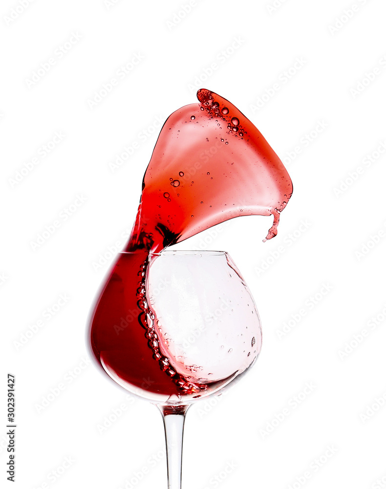 Glass of wine with splash on white background