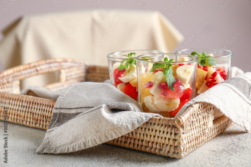 Glasses with tasty fruit salad on table