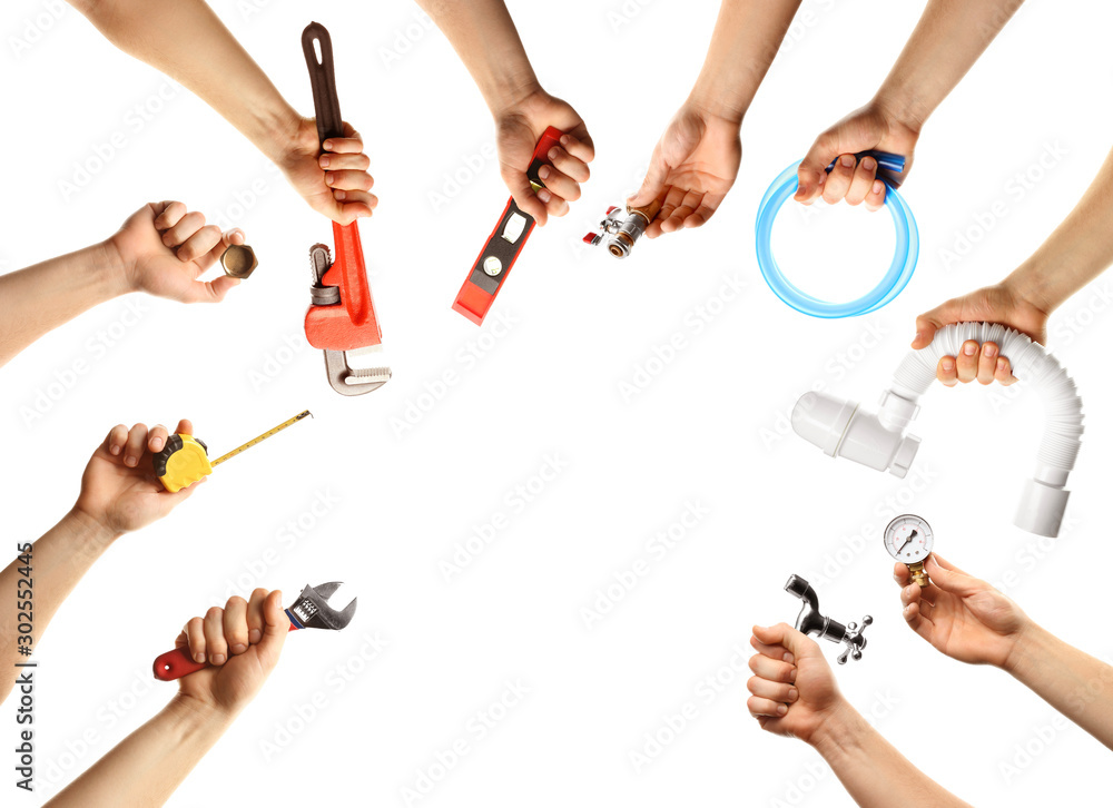 Hands with different plumber tools on white background