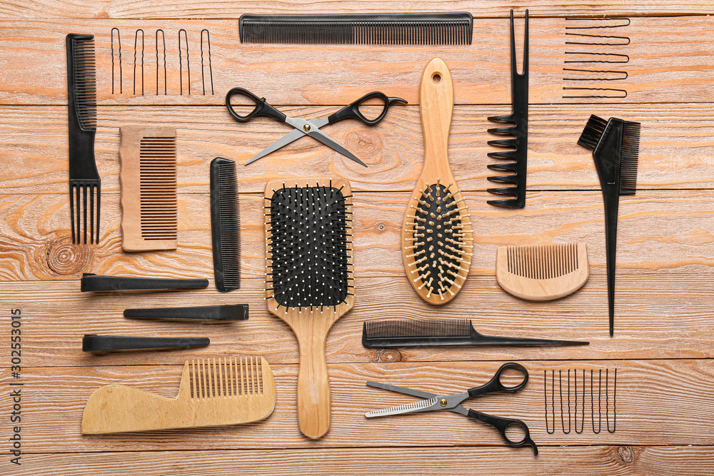 Set of hairdresser tools on wooden background