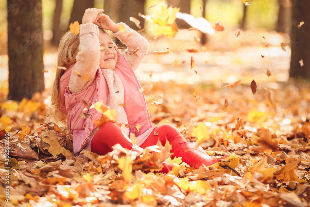 Cute little girl having fun in autumn park