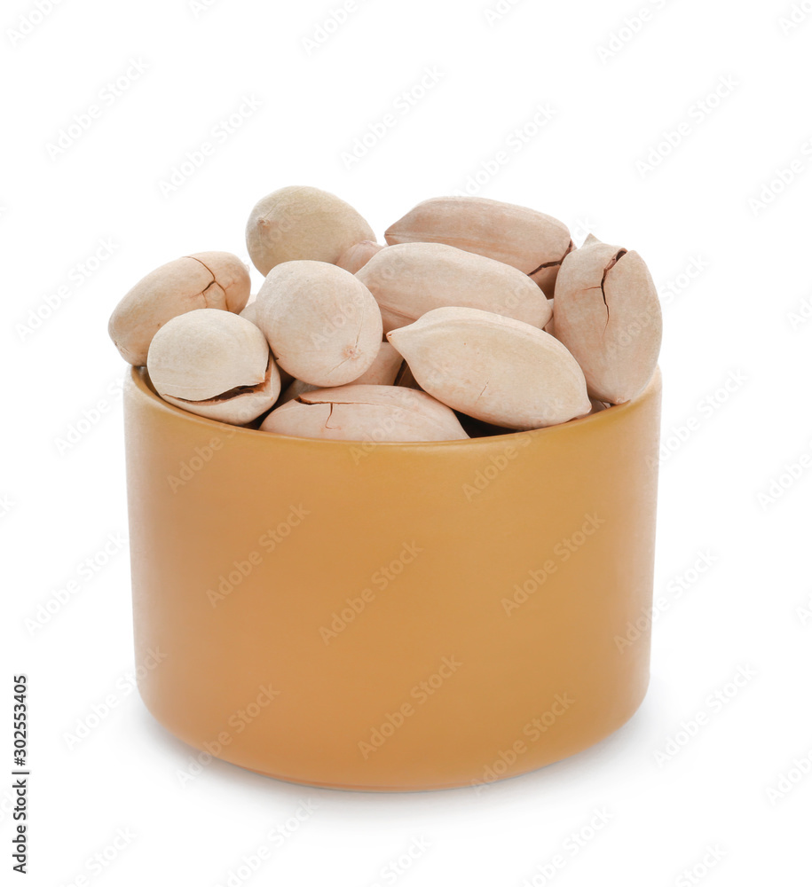 Bowl with tasty pecan nuts on white background