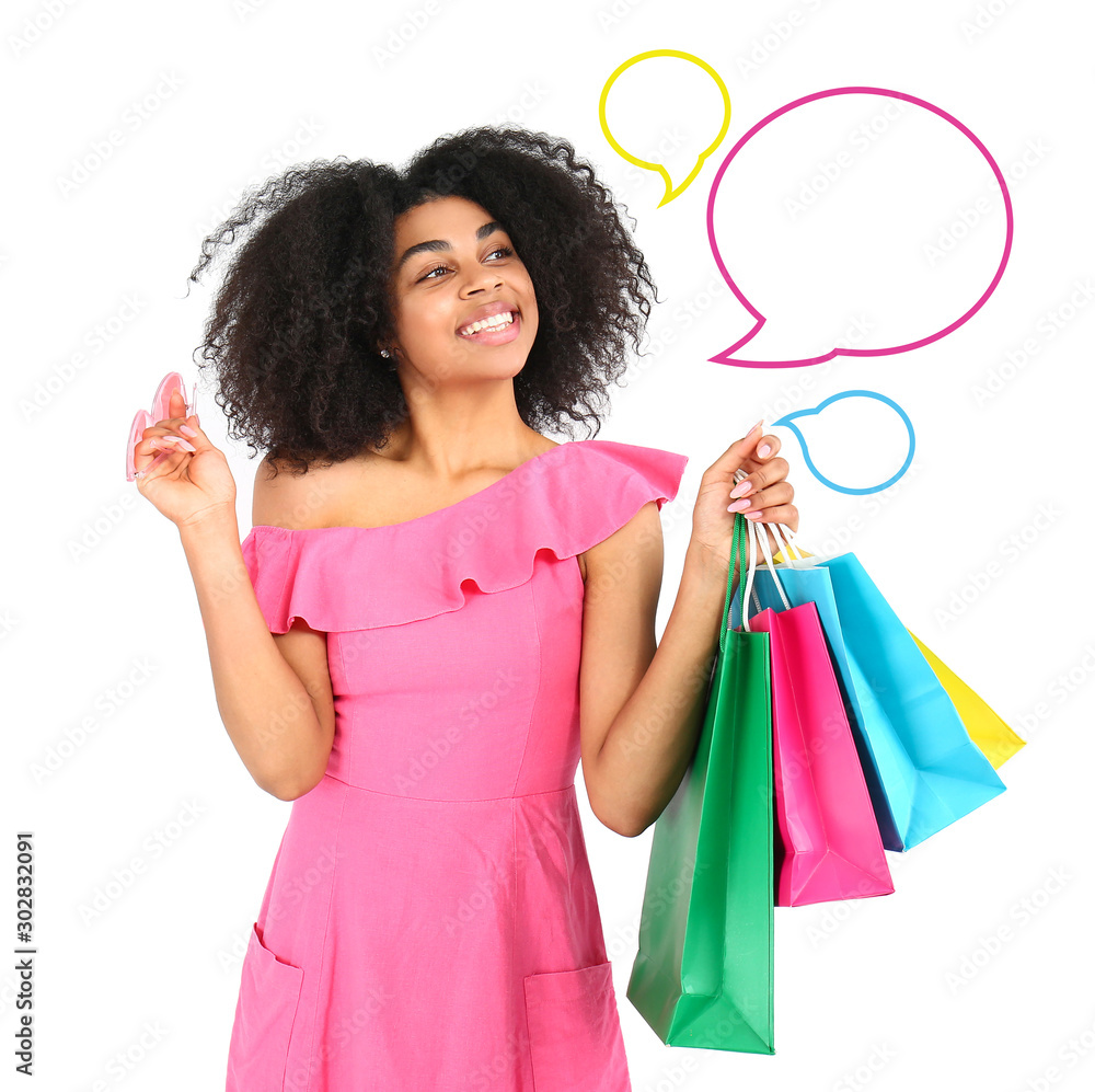 Beautiful African-American woman with shopping bags and with blank speech bubbles on white backgroun