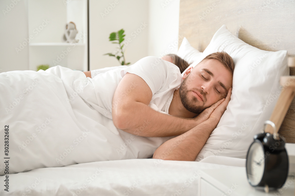 Morning of young man sleeping in bed