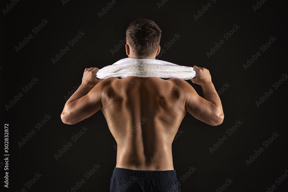 Handsome male bodybuilder on dark background