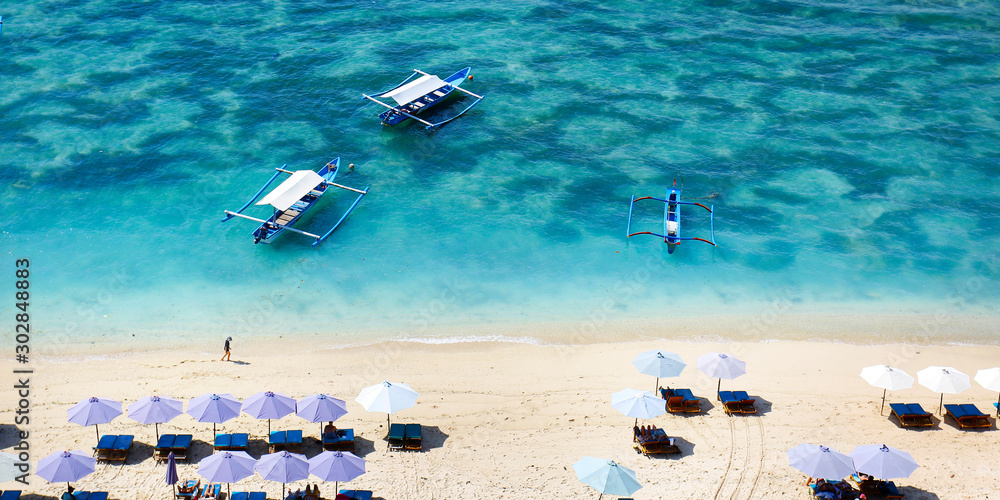  boat on white sand beach in bali -indonesia