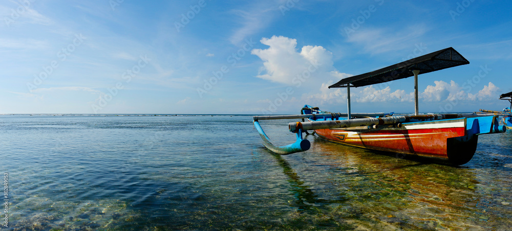  boat on white sand beach in bali -indonesia