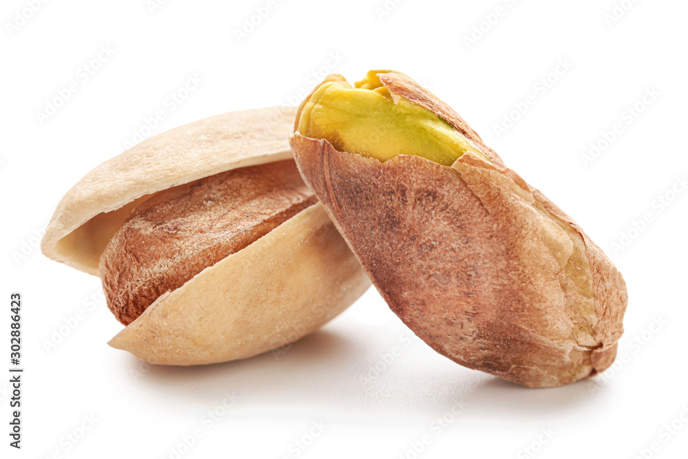 Tasty pistachio nuts isolated on white