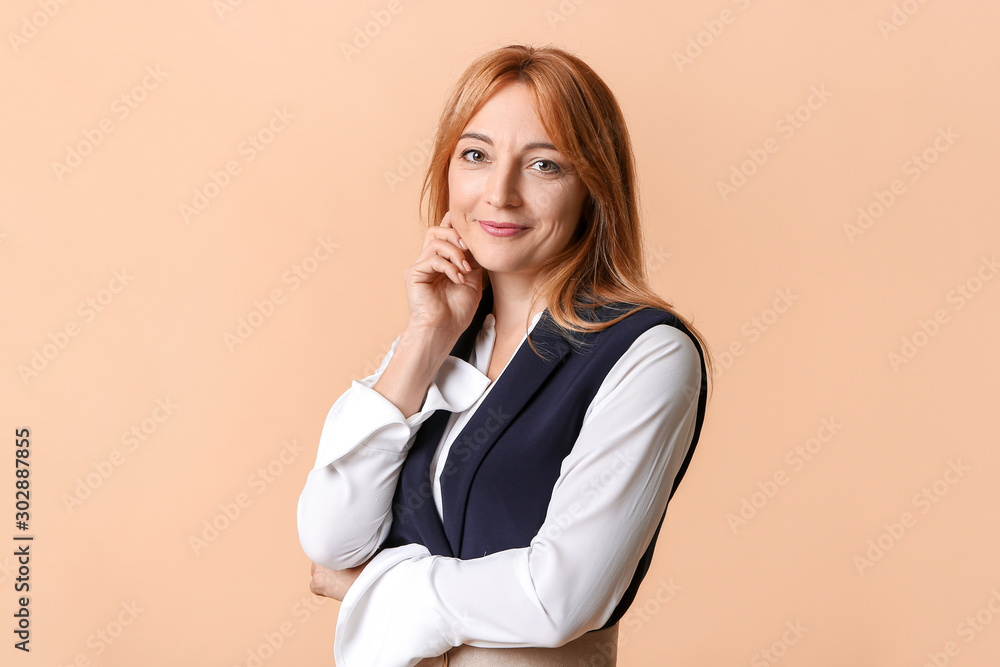 Stylish mature businesswoman on color background