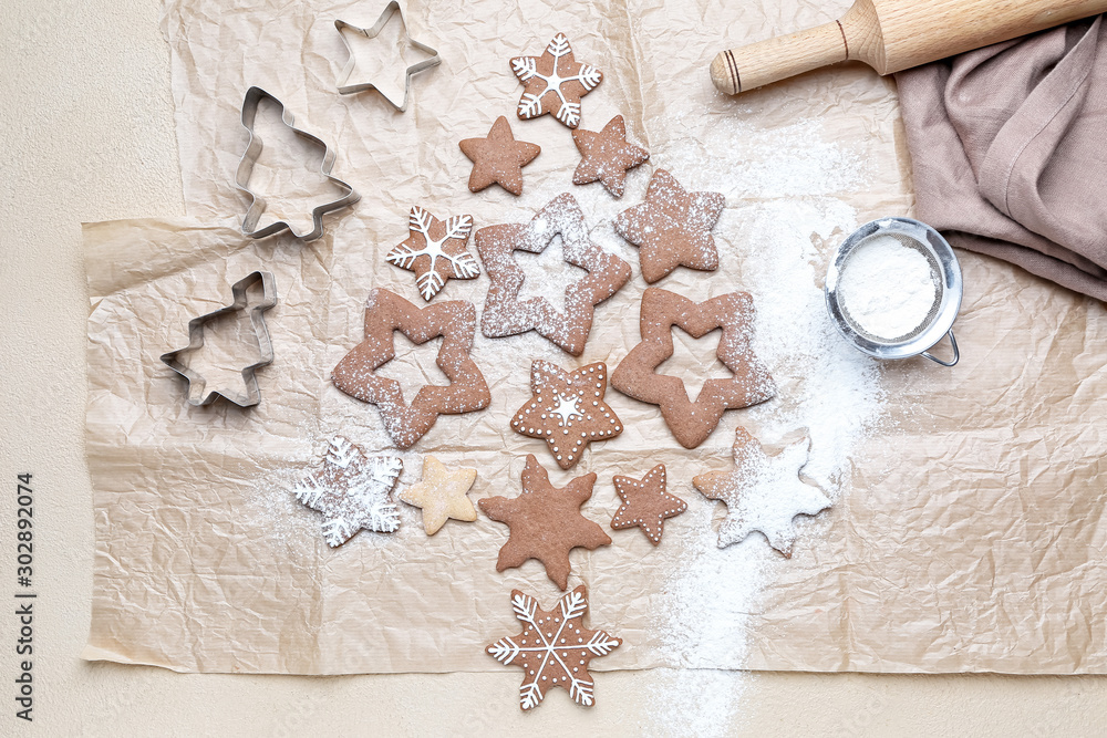 Christmas tree shape made of tasty cookies on light background