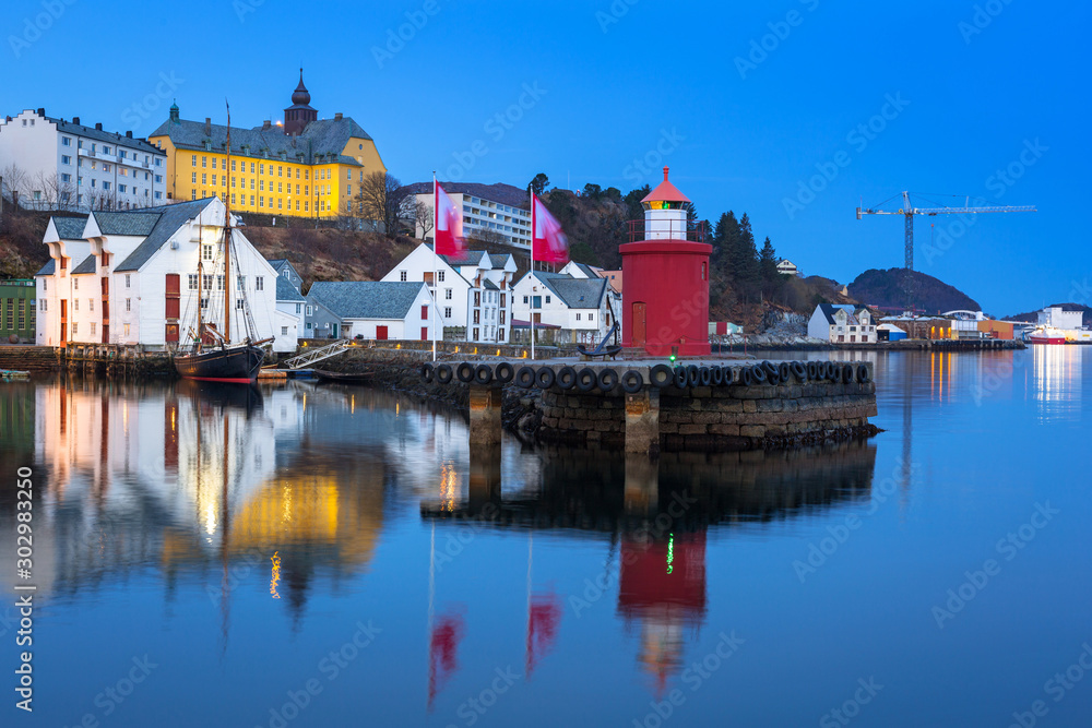 Architecture of Alesund town reflected in the water at dawn, Norway