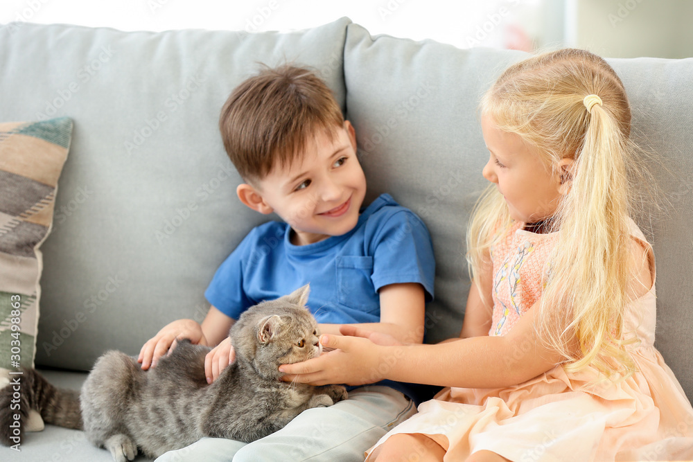 Little children with cute cat at home