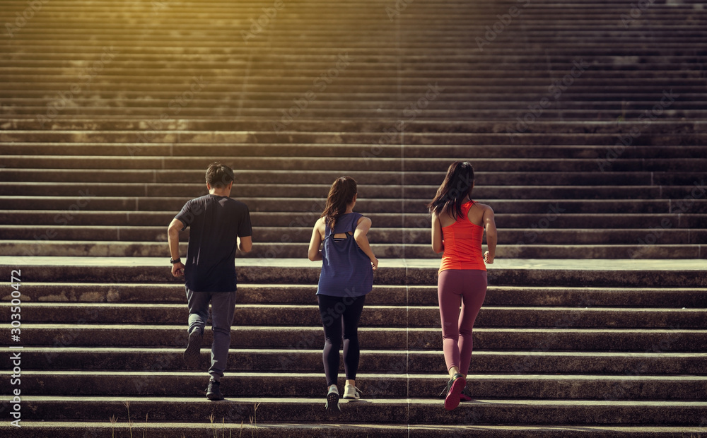 Asian friends group jogging up the stairs