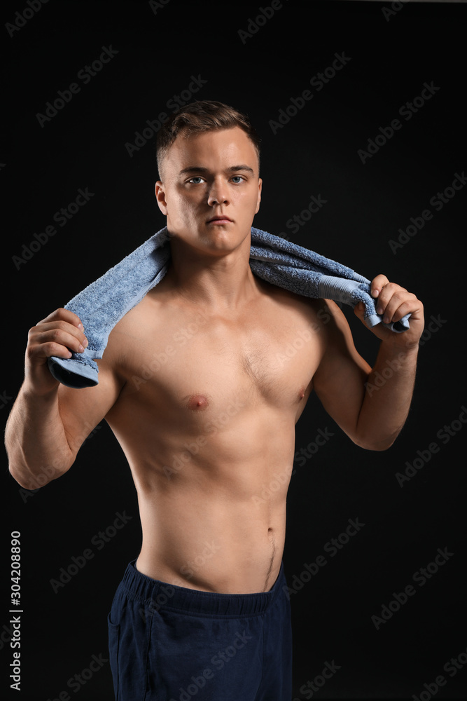 Handsome male bodybuilder on dark background