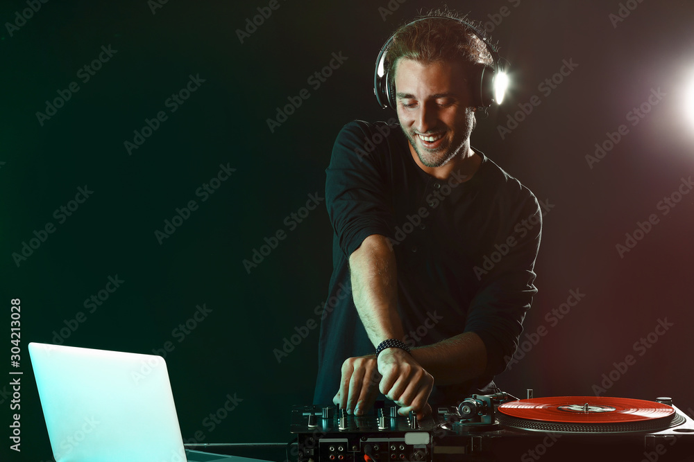 Male dj playing music in nightclub