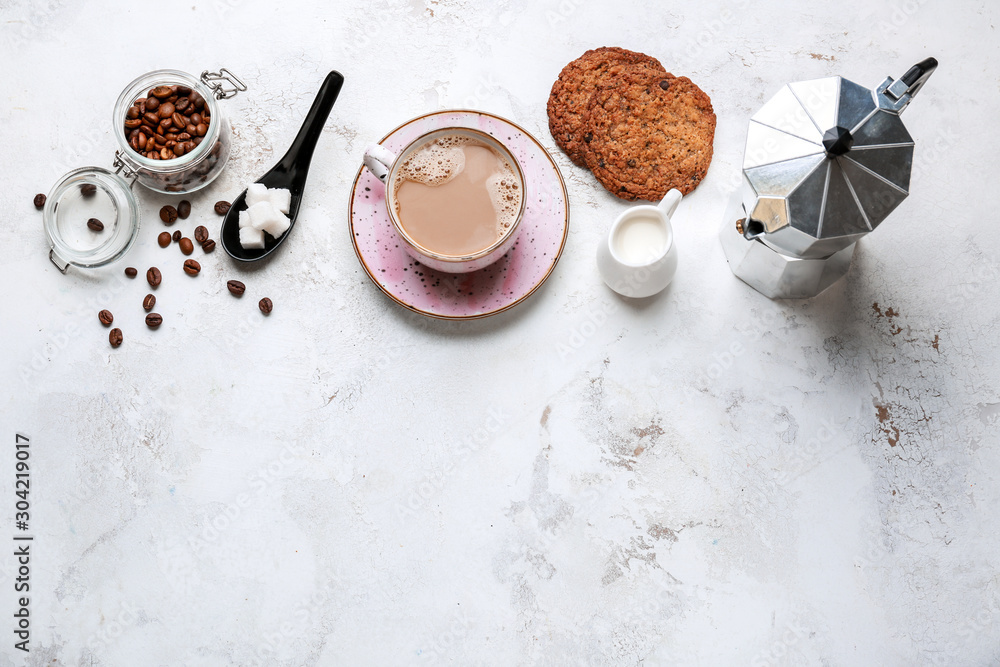 Cup of hot coffee with milk, sugar and cookies on light background