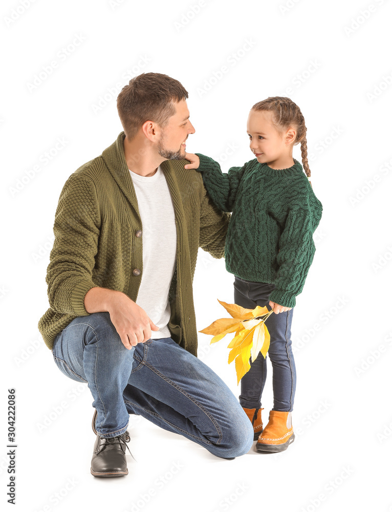 Portrait of happy father and daughter with autumn leaves on white background