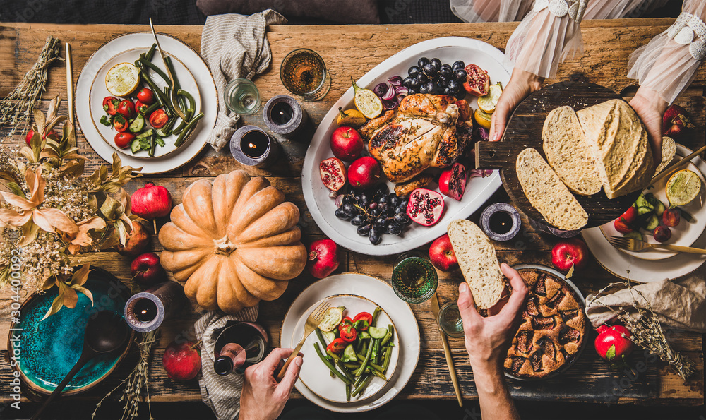 Thanksgiving party table setting. Flat-lay of whole roasted chicken, vegetables, fig pie, fruit, pum