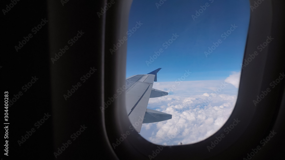 Flight during overcast weather. View from the window of the airplane on the wing, sky and clouds. Sl