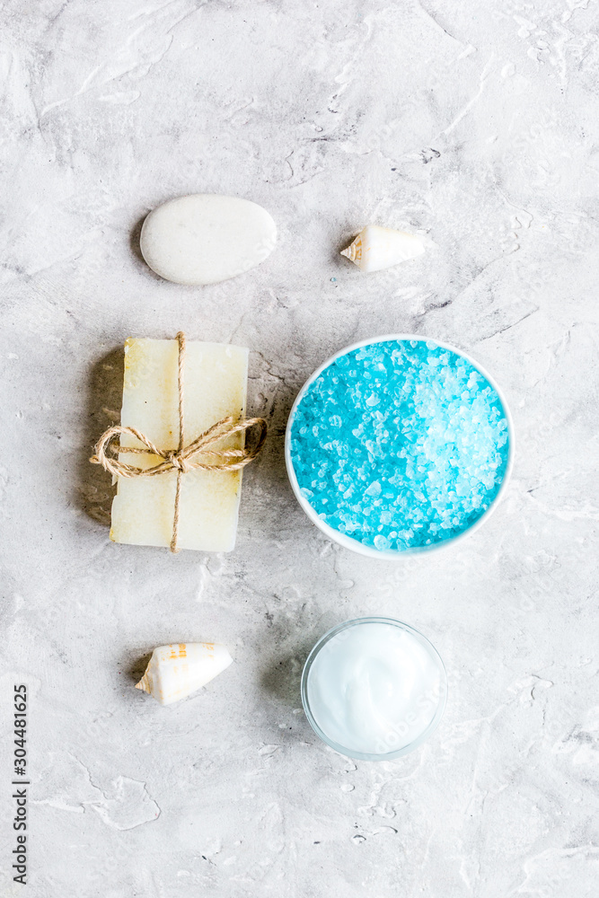 blue salt, body cream and shells for spa bath background top view mockup