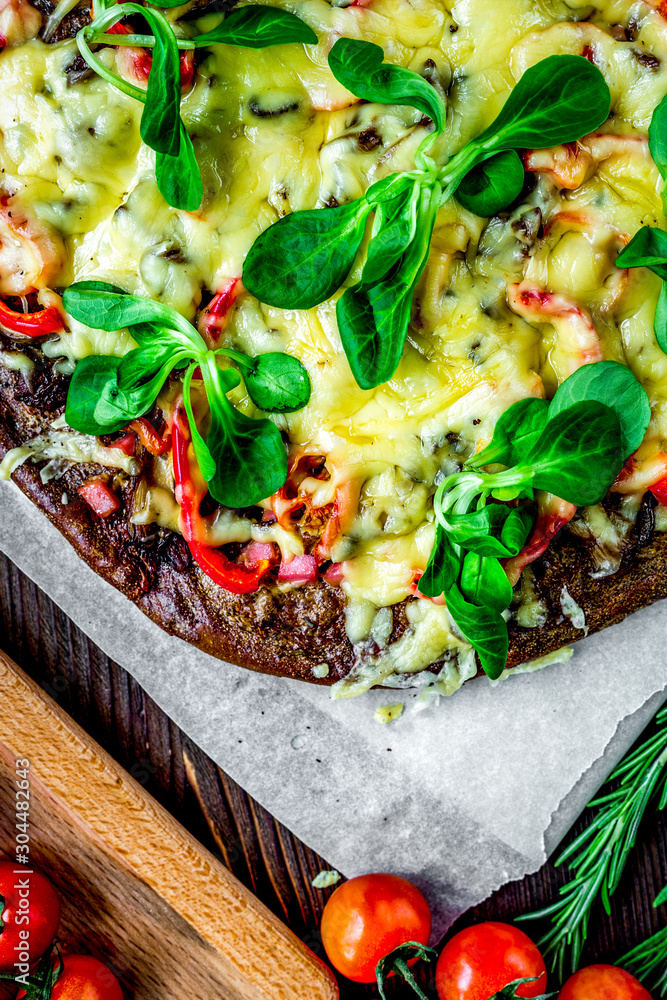 cooking pizza with vegetables and cheese on wooden desk background top view