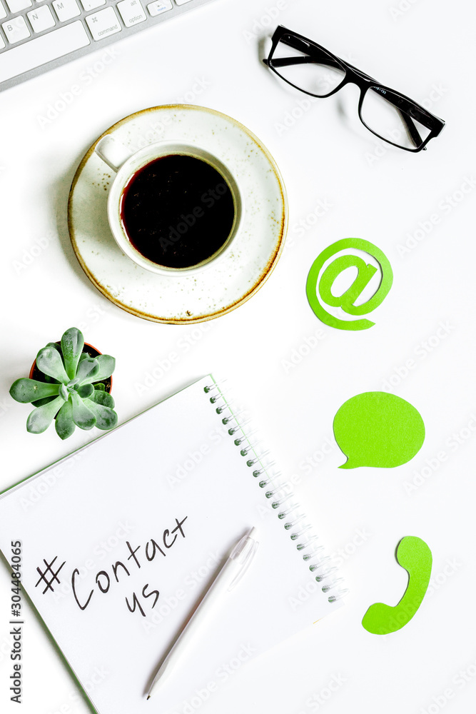 e-mail contact us concept with internet icons and glasses work desk background top view