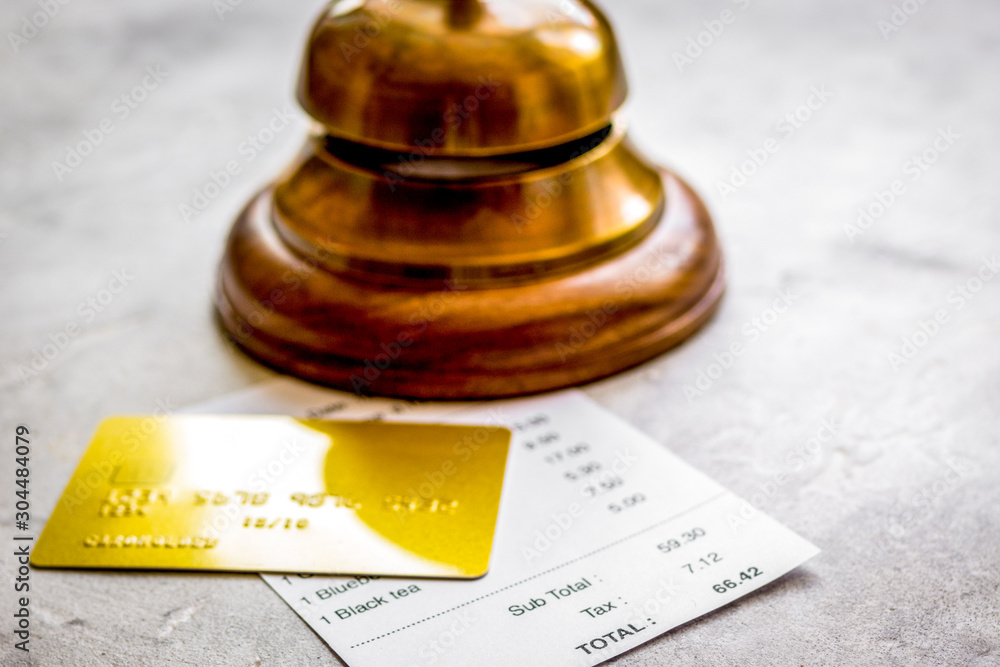 restaurant bill paying by credit card and ring on stone table background