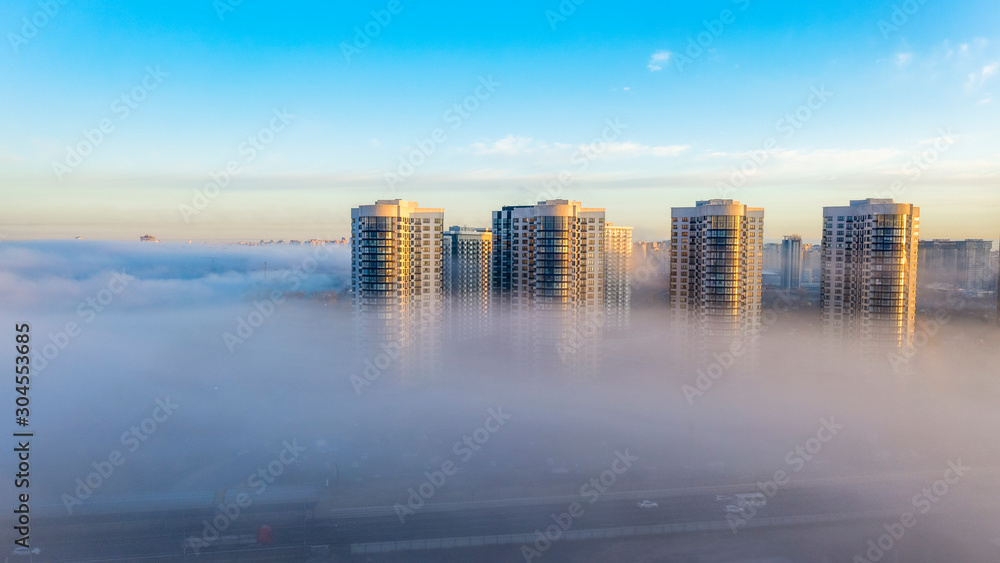 High-rise buildings in the morning autumn fog