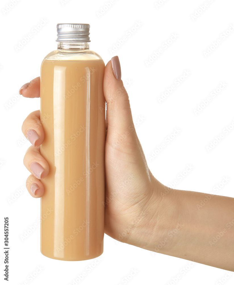 Female hand with cosmetic product in bottle on white background