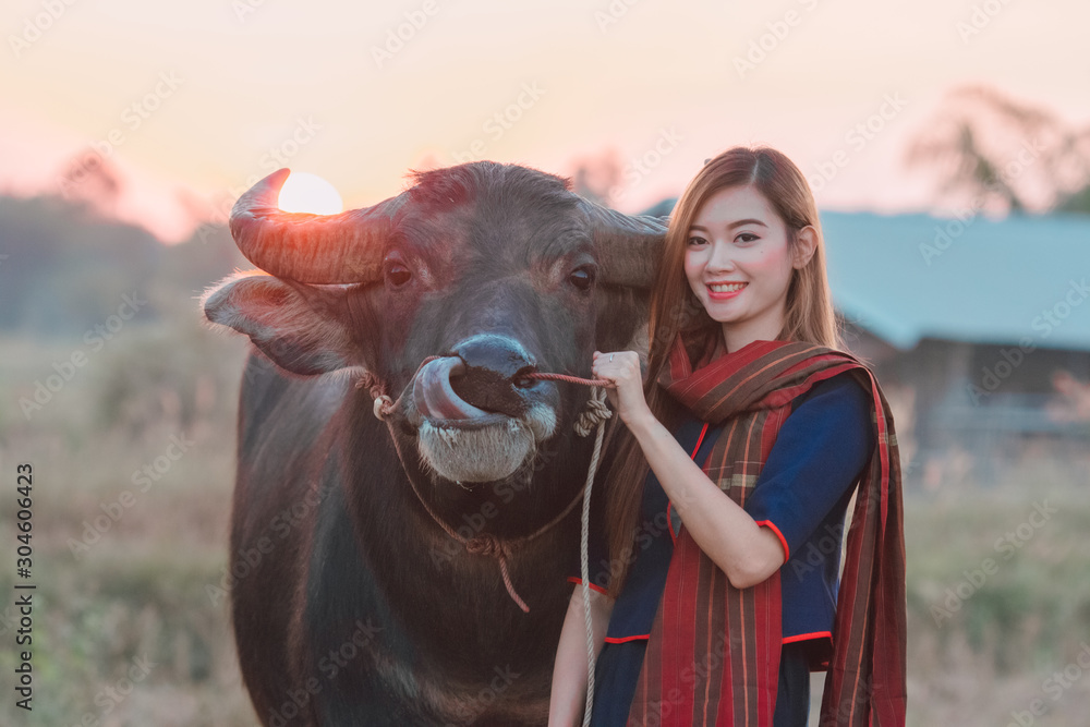 Young girl farmer with buffalo,Asia,Thailand.