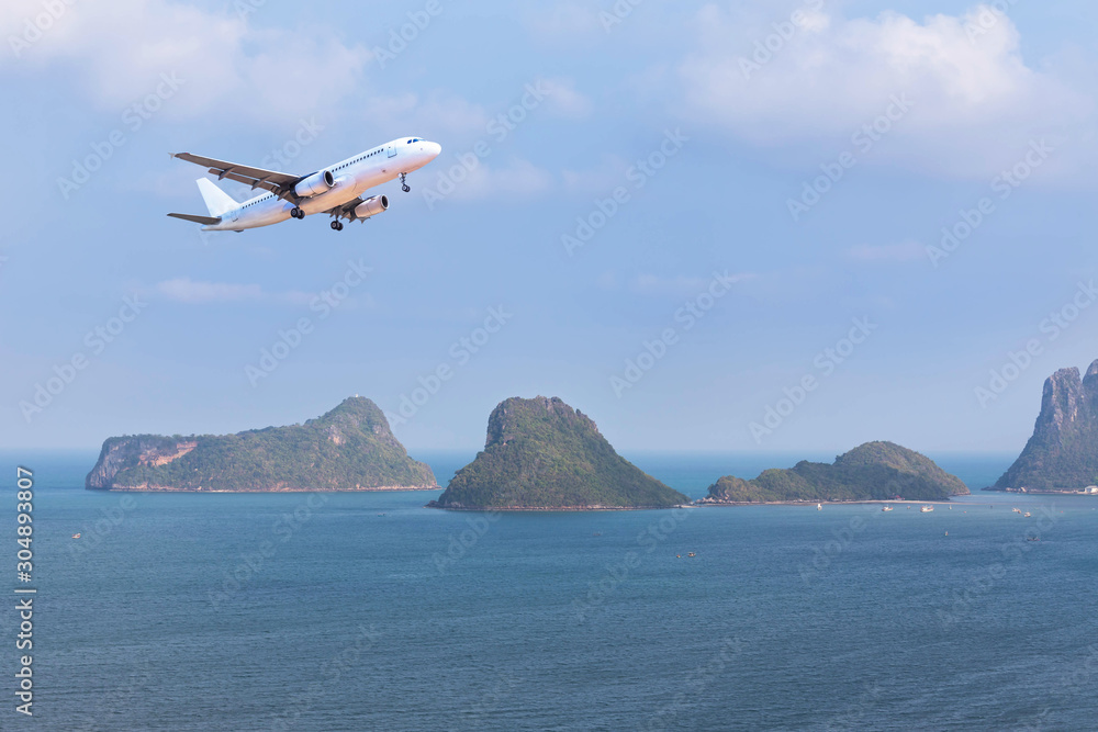                   Aerial  landscape view white passenger airplane landing above group of small islan