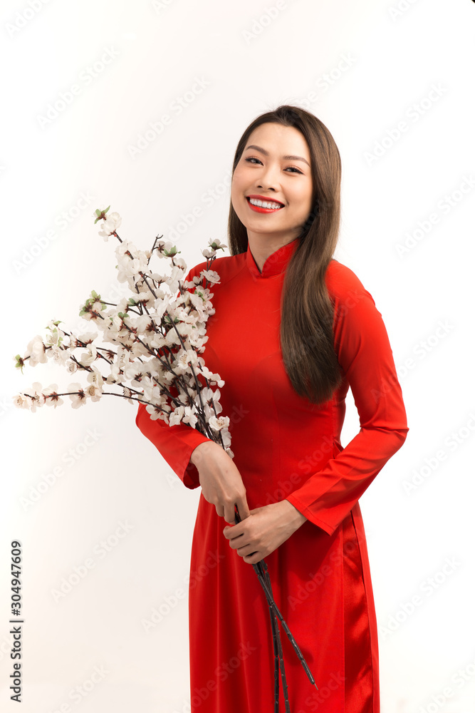 Asian girl in ao dai, concept celebrating Lunar New Year or spring festival, isolated on white backg