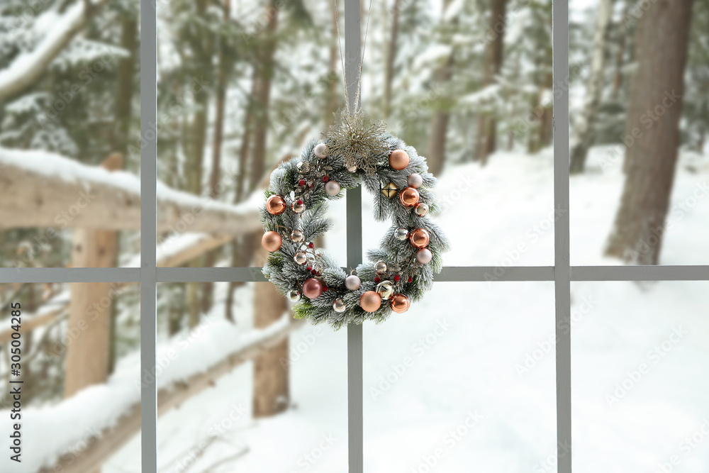 Beautiful Christmas wreath hanging on window