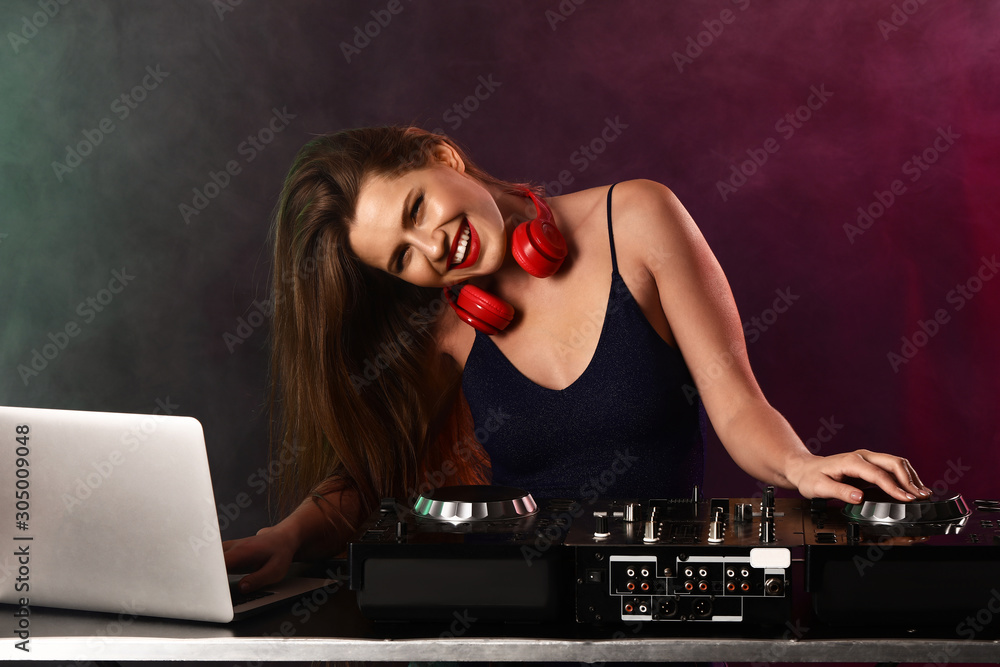 Female dj playing music in nightclub