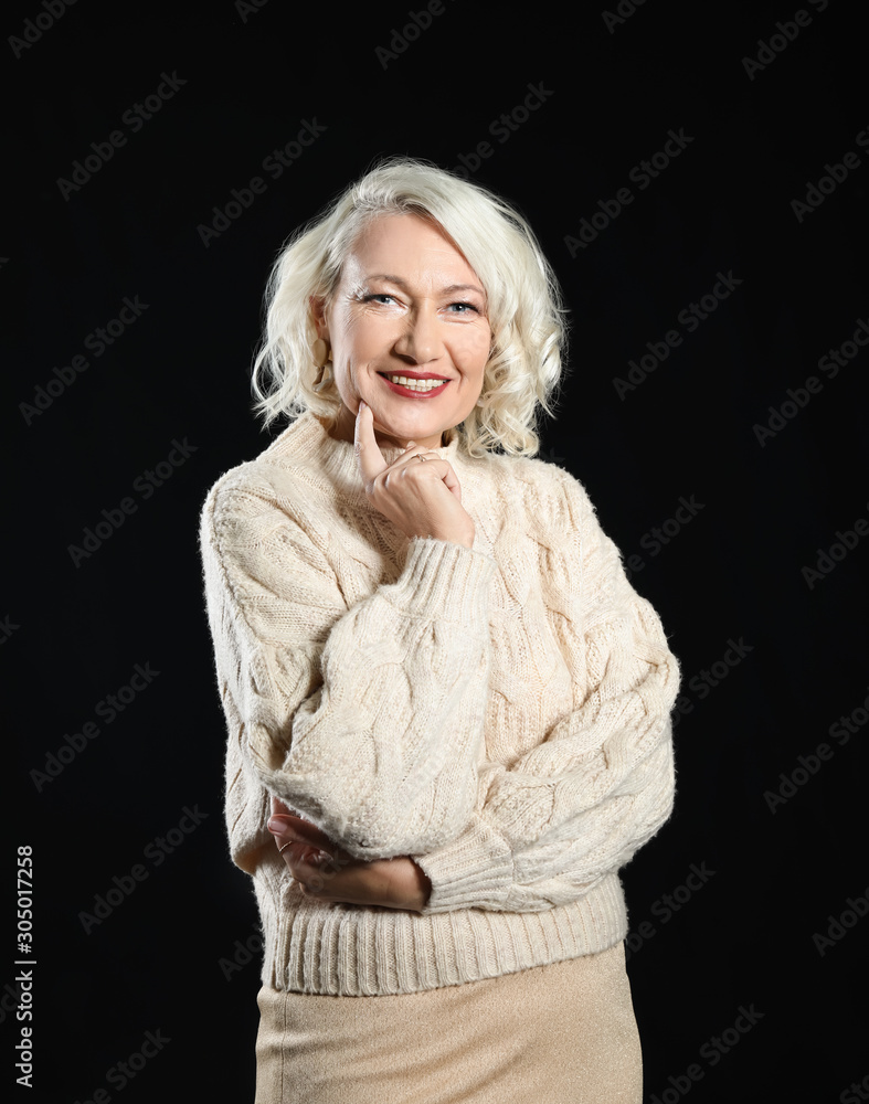 Portrait of stylish mature woman on dark background