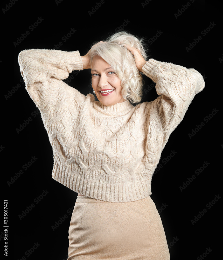 Portrait of stylish mature woman on dark background