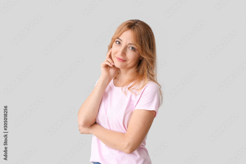 Stylish mature woman on light background