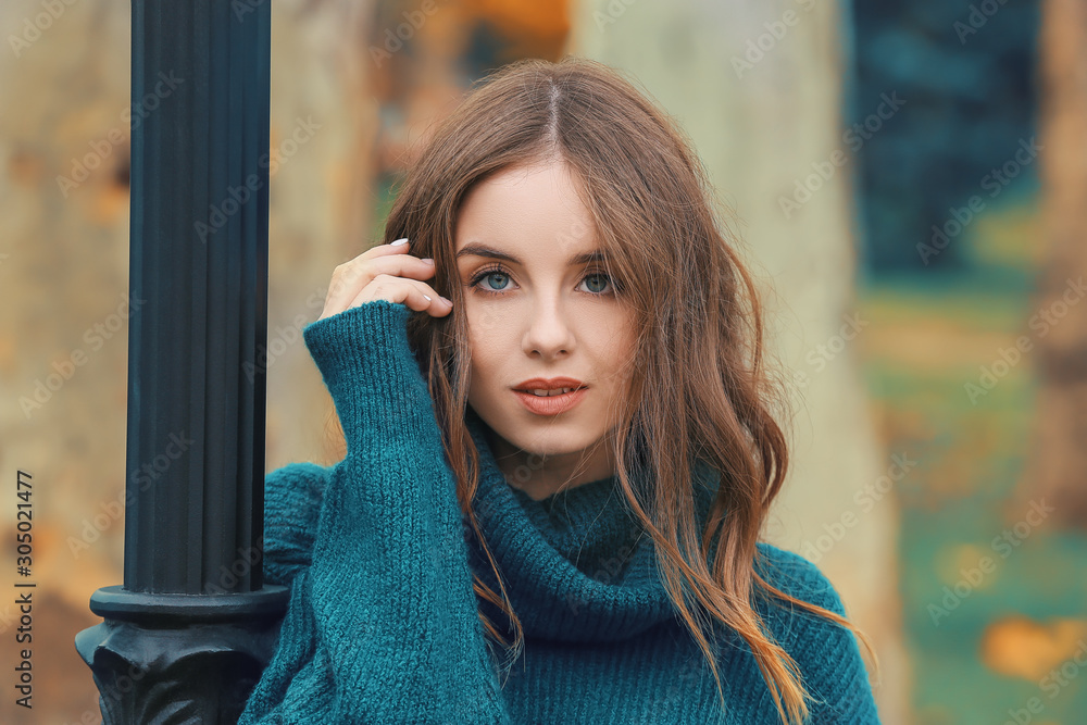 Portrait of stylish young woman on autumn day