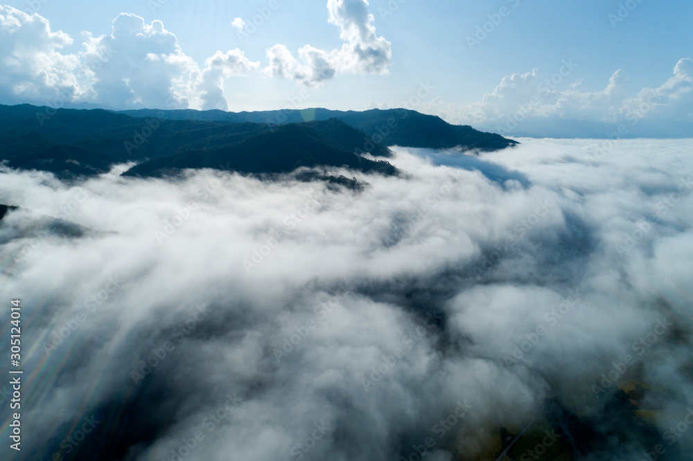 Aerial view drone shot of flowing fog waves on mountain tropical rainforest,Bird eye view image over