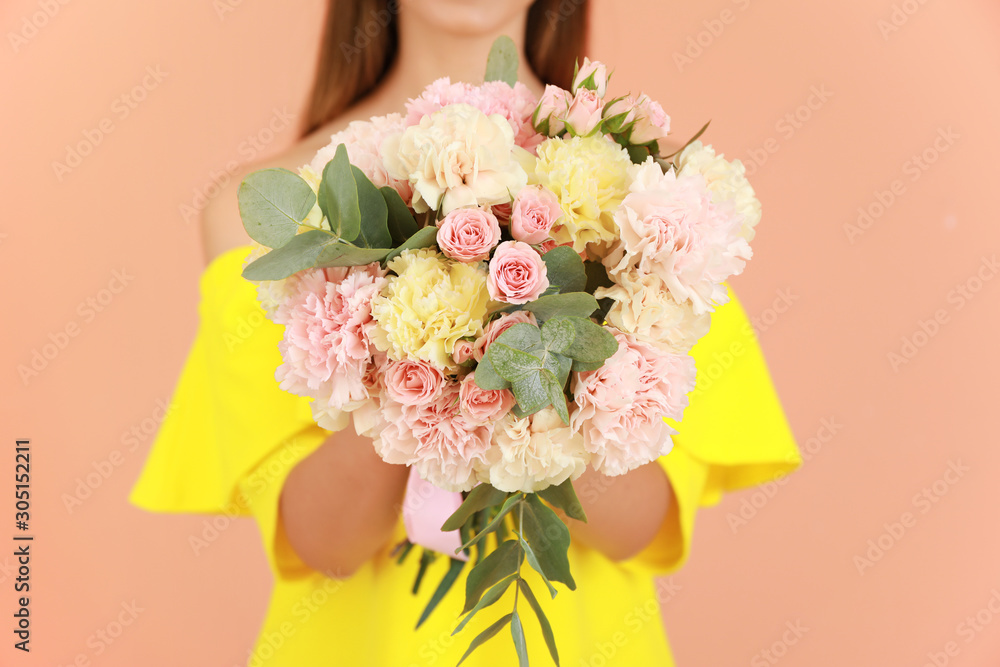 Beautiful young woman with bouquet of carnation flowers on color background