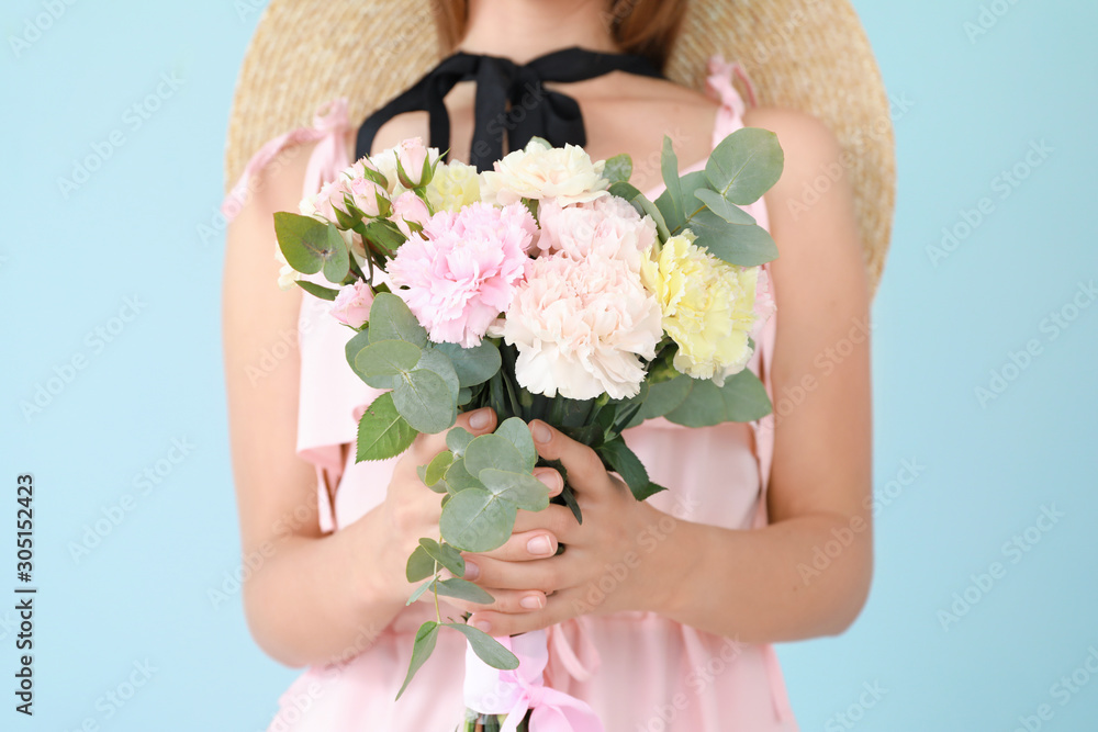 Beautiful young woman with bouquet of carnation flowers on color background, closeup