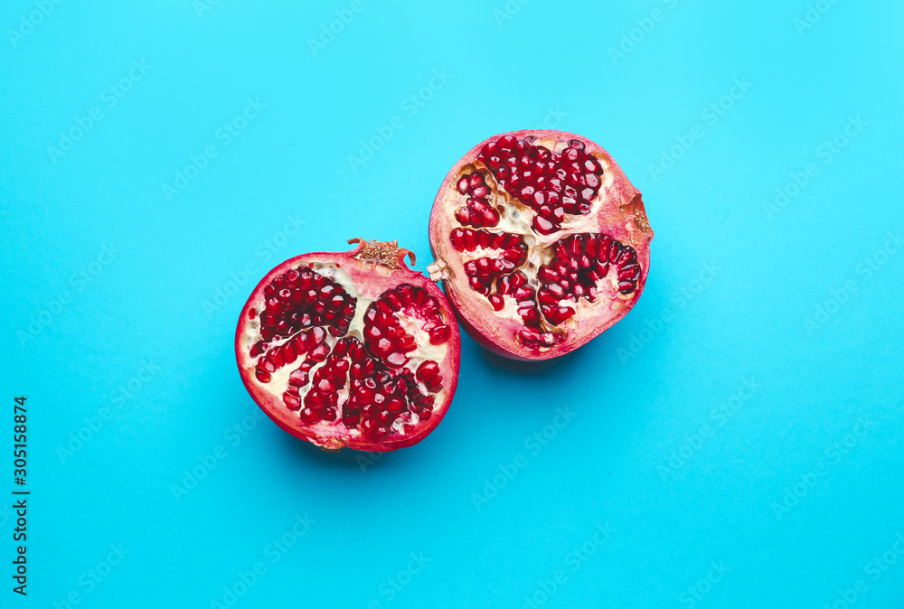 Ripe tasty pomegranates on color background