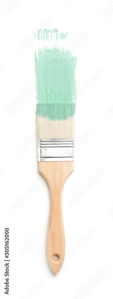 Brush with paint on light background