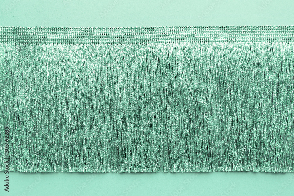 Turquoise curtain fringe on color background